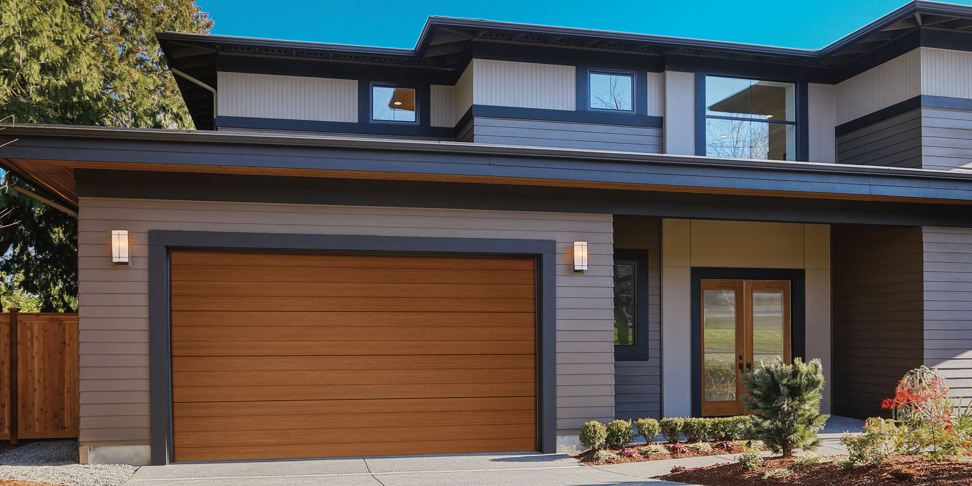 Brown garage door in a private grey house