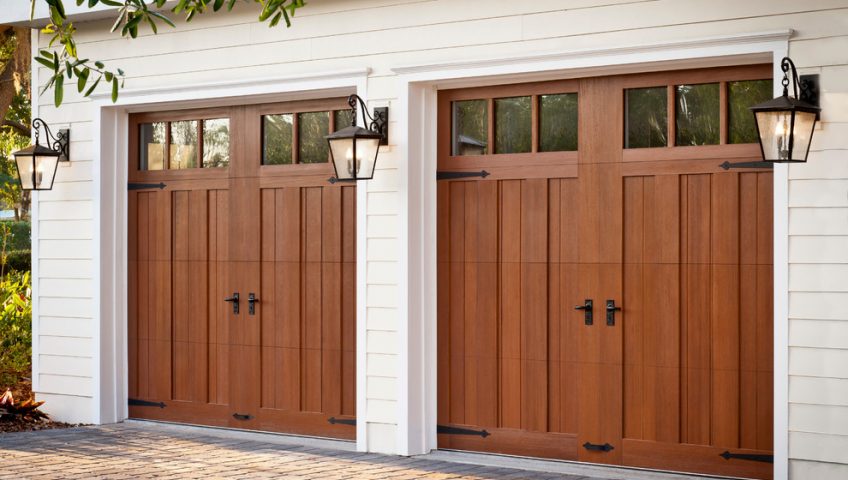 Red wood garage doors and white house