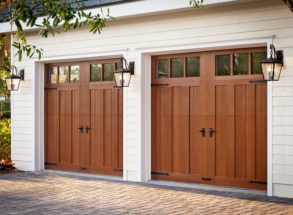 Red wood garage doors and white house