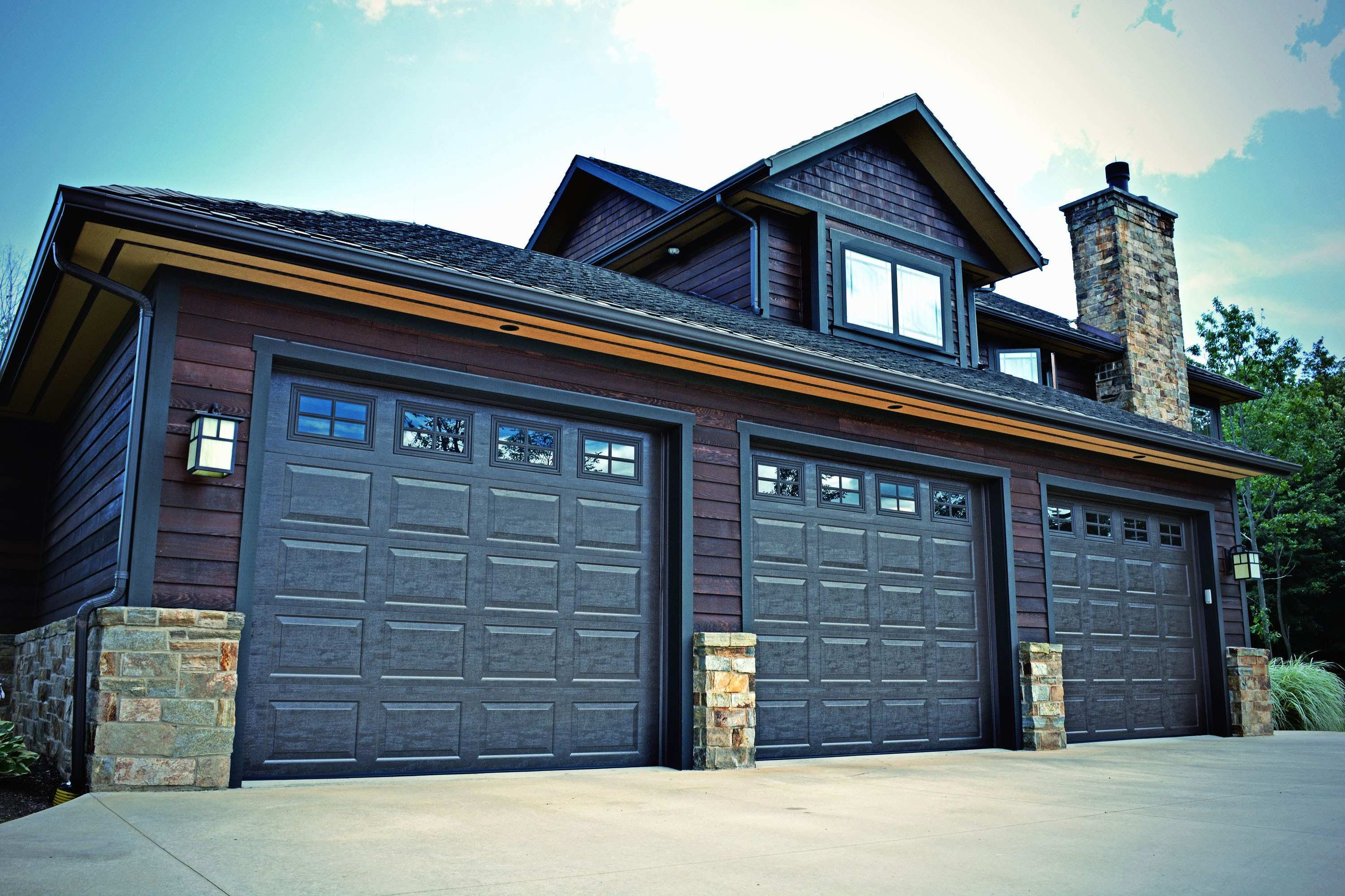 Three closed dark garage doors