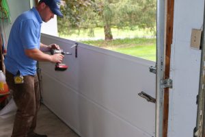 Man repairs garage door